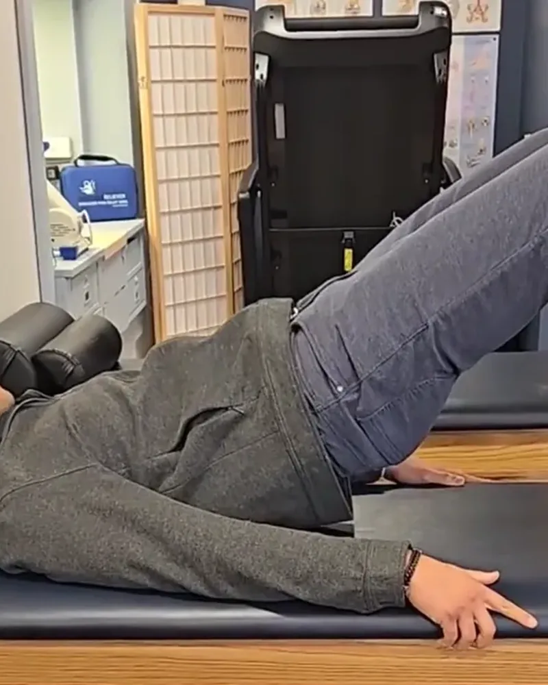 Patient performing a guided exercise on a treatment table at Maritime Physical Therapy