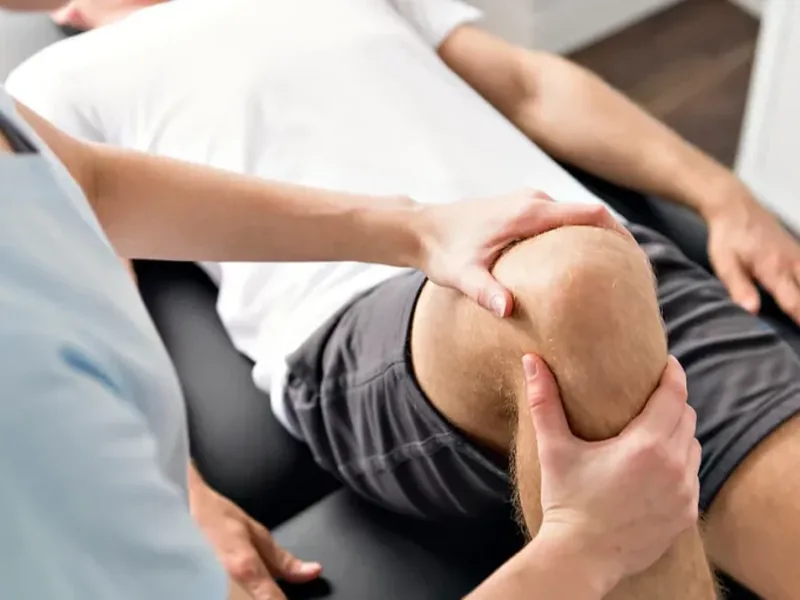 Physical therapist assessing hip and knee mechanics